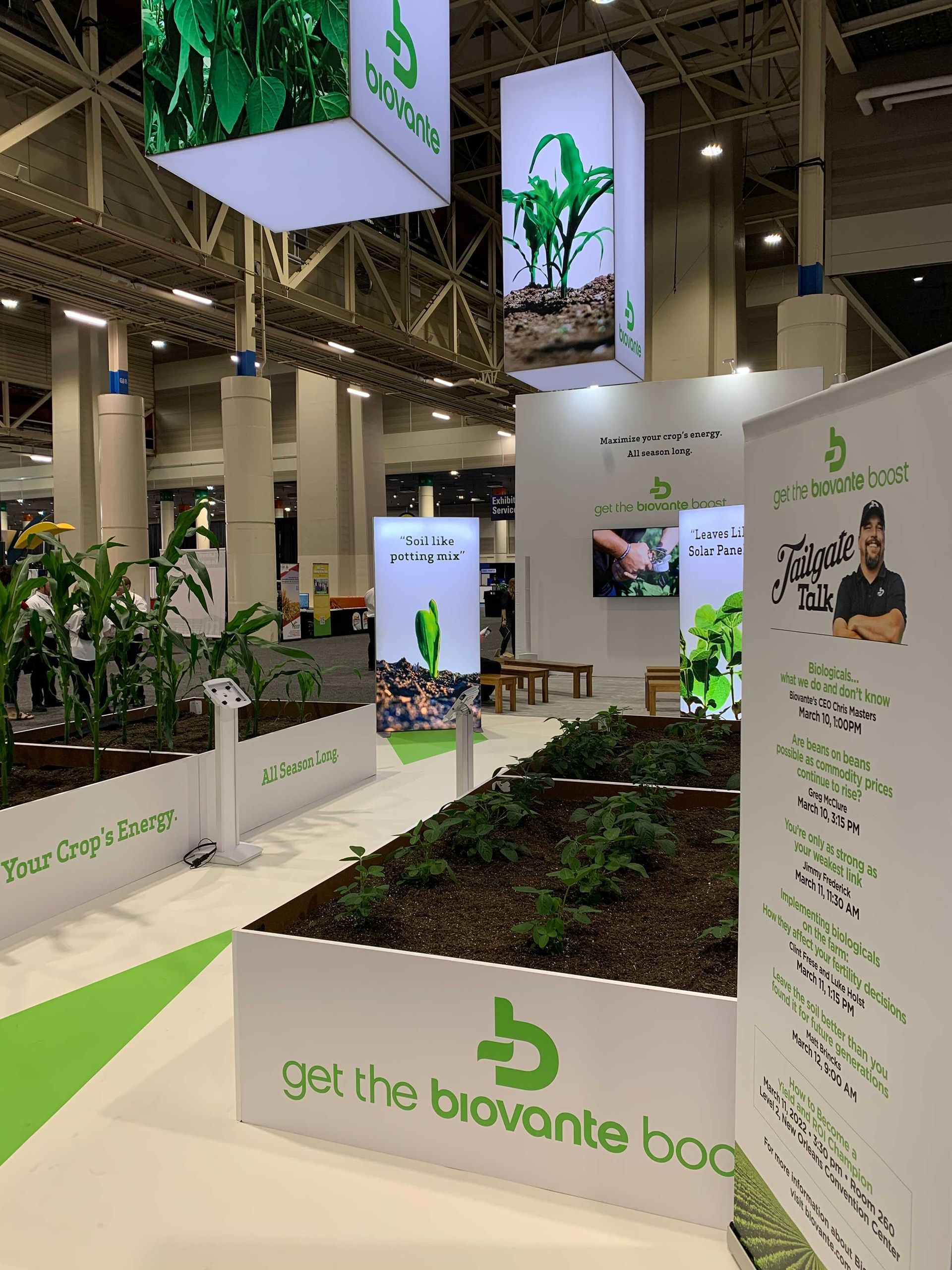 A man demonstrates plant roots at a Biovante exhibition booth.