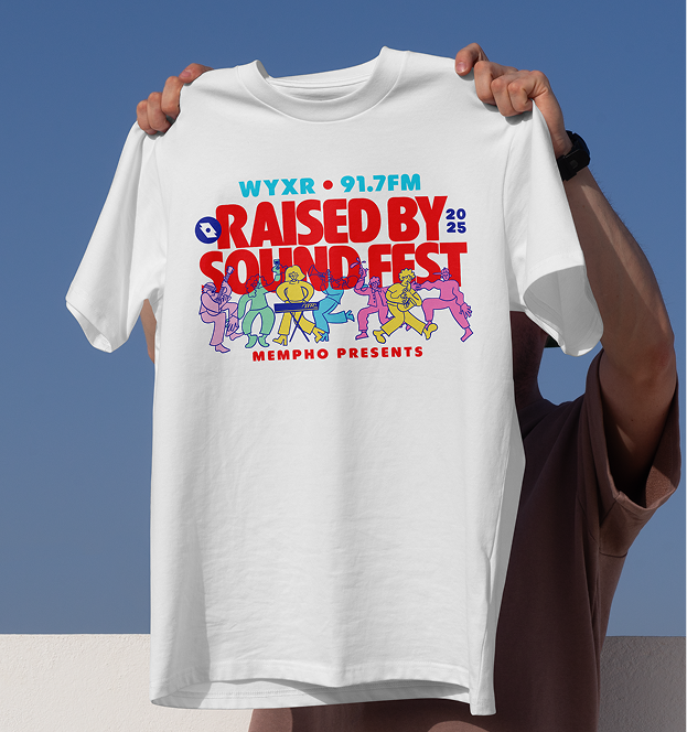 White festival tee held against blue sky reading "WYXR 91.7FM Raised By Sound Fest 2025" with dancing character illustrations.